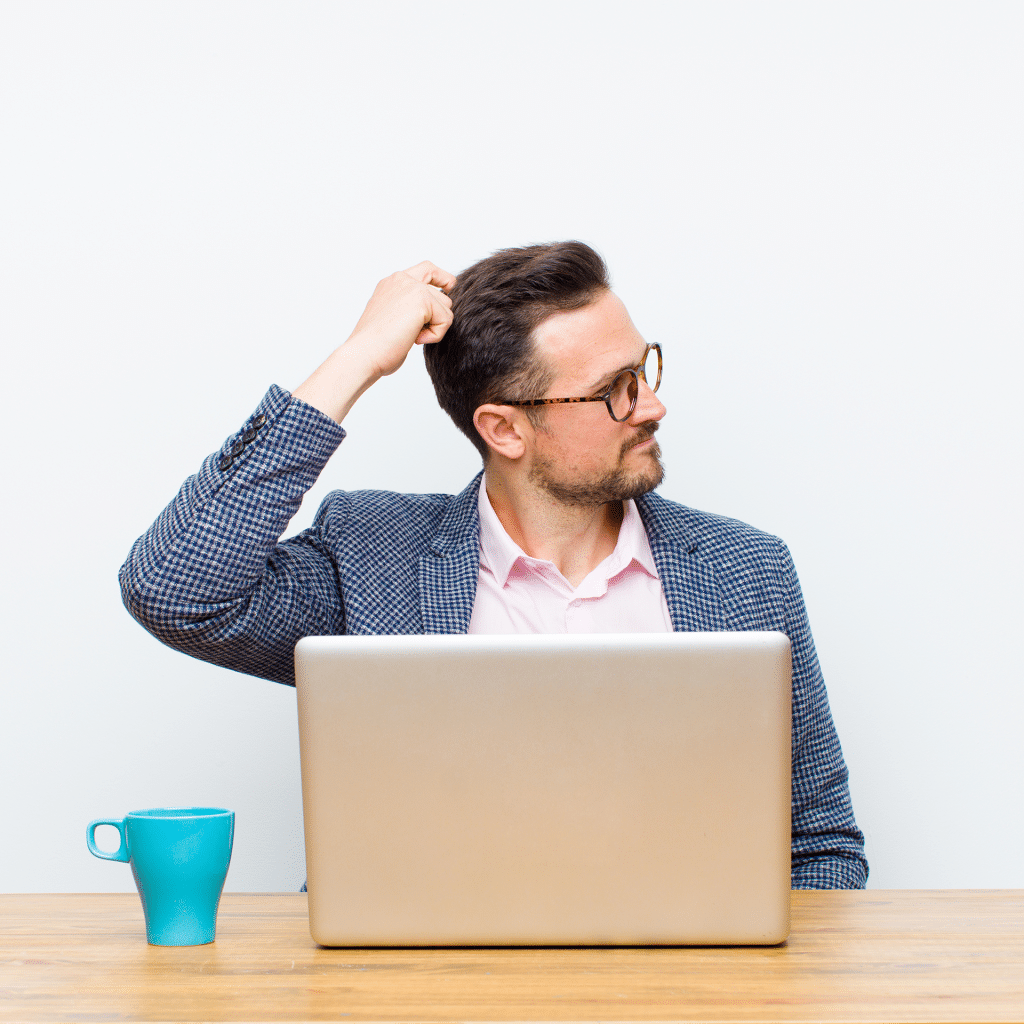 man confused using laptop